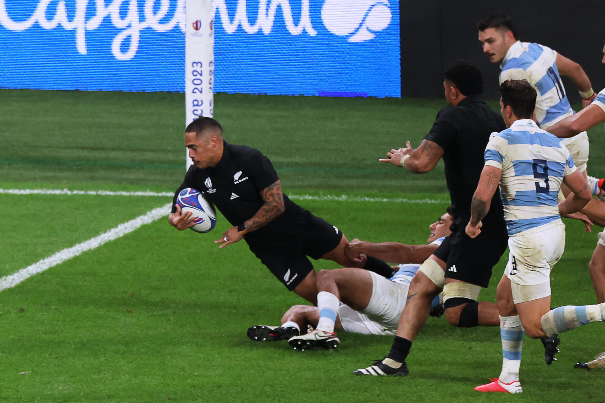 Le demi de mêlée des All Blacks Aaron Smith s'apprête à mparquer un essai lors de la demi-finale du la coupe du monde de rugby remportée contre l'Argentine au Stade de France à Saint-Denis, le 20 octobre 2023.